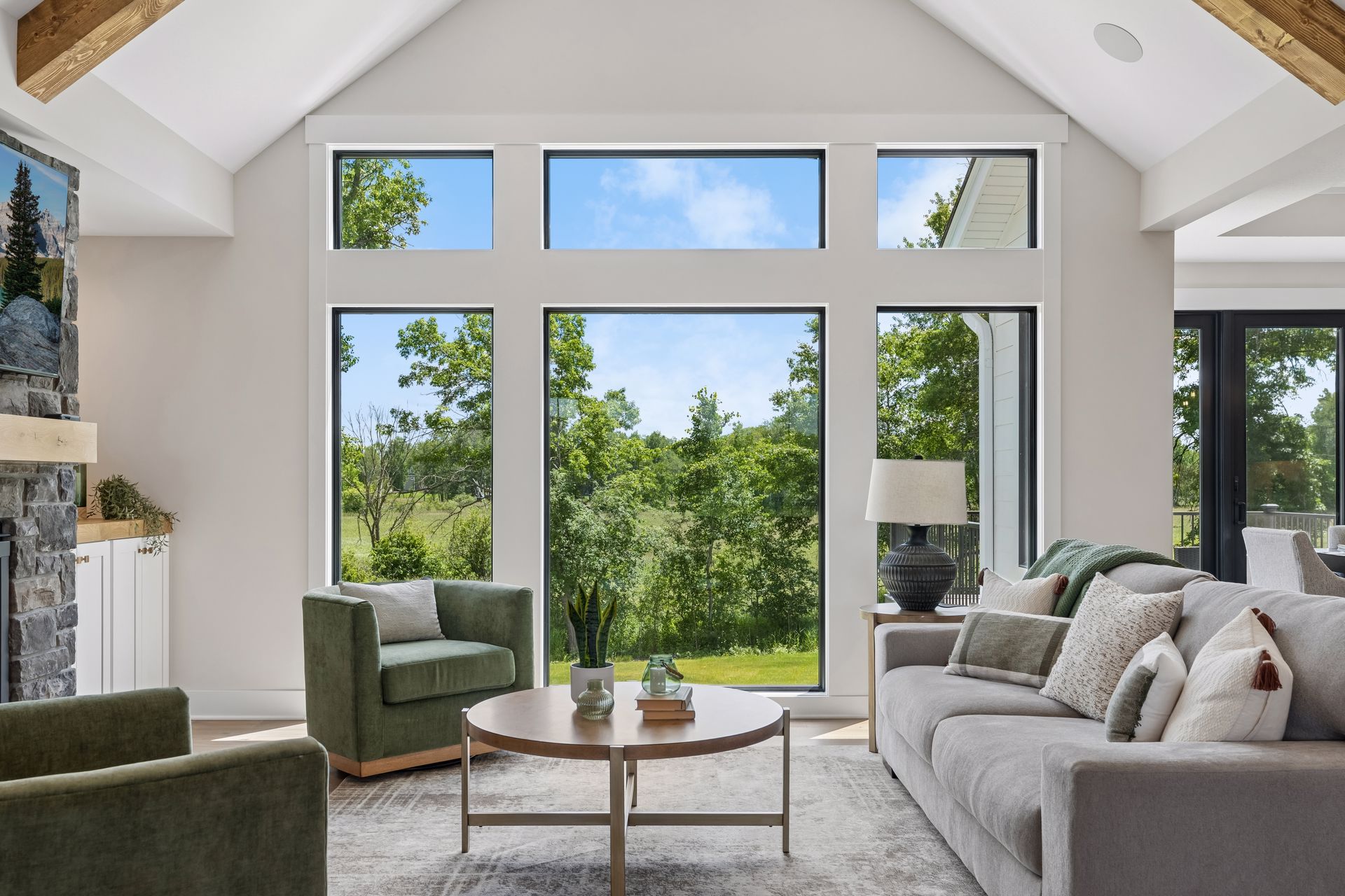 Wall of windows providing natural light and scenic backyard views